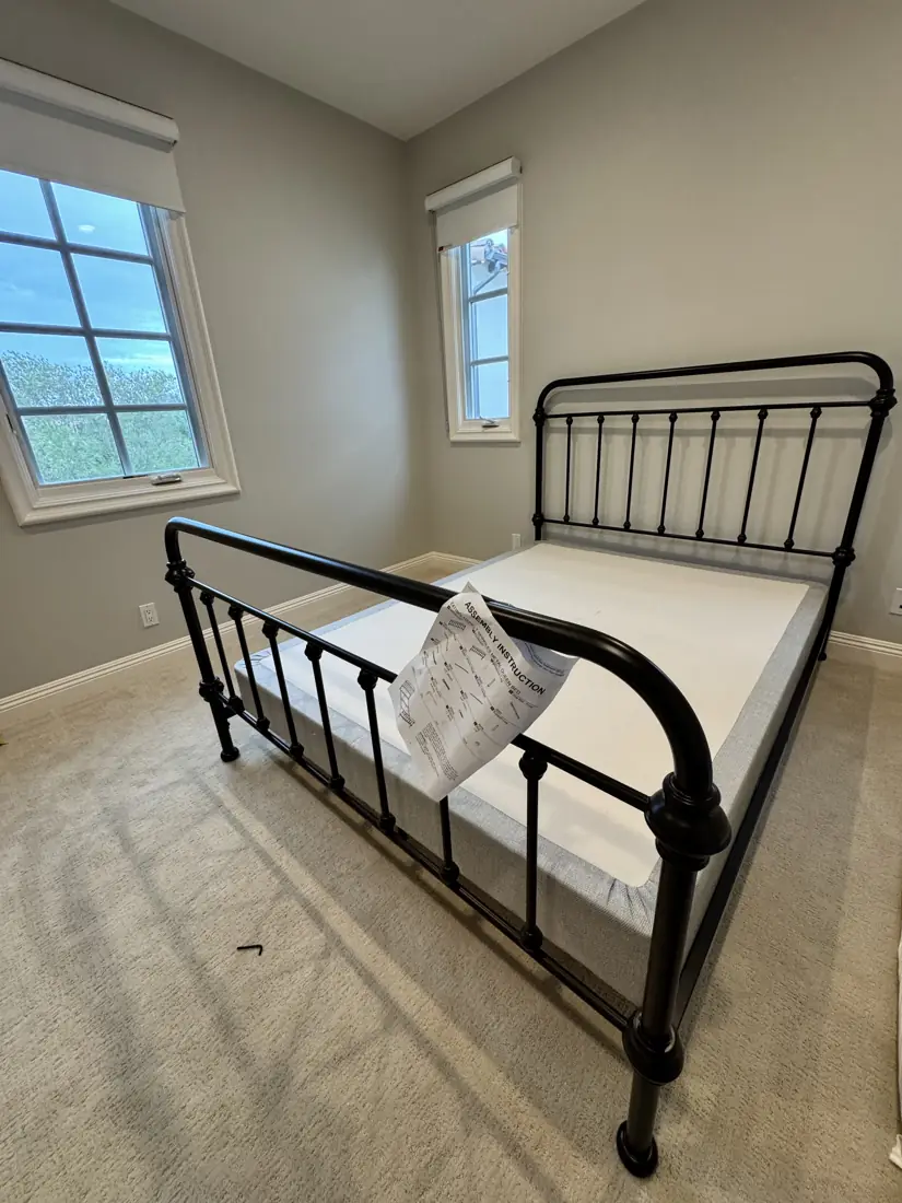Black metal queen bed frame assembled in Corona del Mar, September 2026