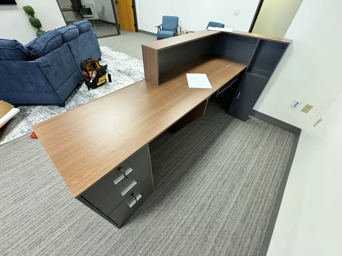 L-shaped reception desk assembled for a Laguna Hills office, August 2026