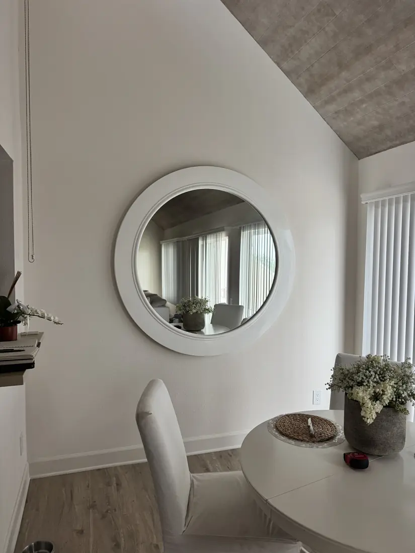 Round wall mirror hung in Newport Beach, September 2026