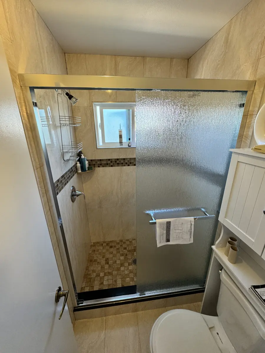 Frameless shower sliding door installed in Fullerton, September 2026