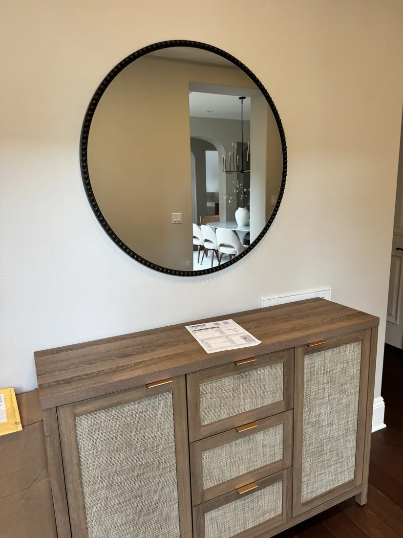 Sideboard assembled and round mirror hung in Newport Beach, September 2026